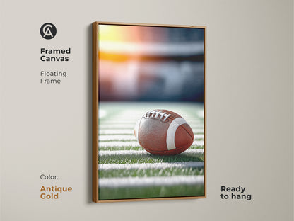 Antique gold framed canvas art. A realistic football is featured on the field. The floating frame is antique gold. This sports fan wall decor is ready to hang. Ideal for a man cave or office football art.