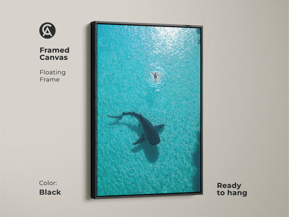 Framed Canvas with a black floating frame featuring an aerial view of a whale shark and swimmer. This turquoise deep blue ocean art is ready to hang. Add coastal charm to your space with this unique wildlife artwork. A perfect housewarming gift.