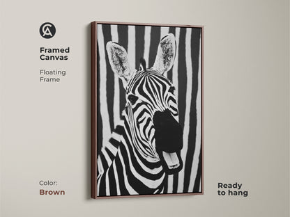 Brown framed canvas featuring zebra art. Ready to hang this floating frame enhances the black and white zebra portrait. A modern animal print with bold stripes it brings minimalist wildlife decor to your bedroom or office. A sophisticated touch.