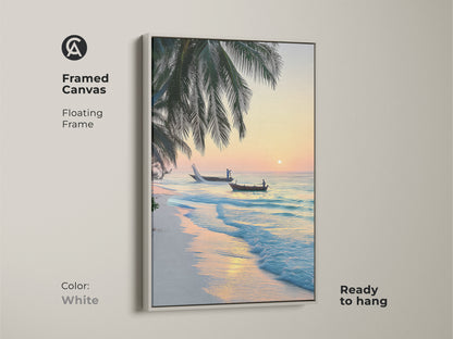 Framed canvas with a white floating frame shows a tropical beach sunrise. The scene includes palm trees and two fishing boats on the turquoise ocean. A perfect coastal art piece.