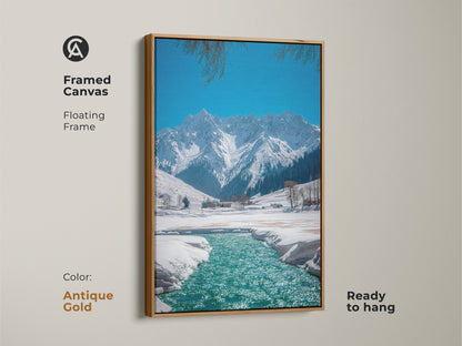 Framed canvas displays winter mountain landscape art with an antique gold floating frame. This ready to hang snowy river canvas print gives rustic nature wall decor. It is an ideal gift idea for outdoor enthusiasts a blue teal landscape painting.