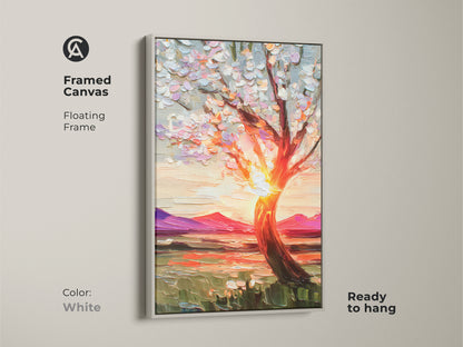 Framed canvas art showcases a textured impressionist blooming tree art against a fiery sunset with a white floating frame. This artwork is a perfect piece of boho home decoration adding warmth to any space. The vibrant nature decor is a thoughtful housewarming gift art print.
