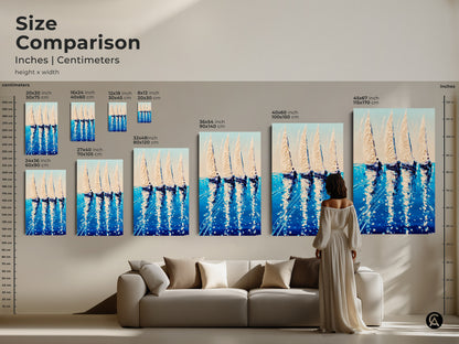 A size comparison of coastal art prints. Deep blue sailboat artwork is shown in various sizes next to a sofa. Explore the impact of different dimensions on your space. Find the perfect nautical wall decor piece to enhance your living room or give as a thoughtful housewarming gift.
