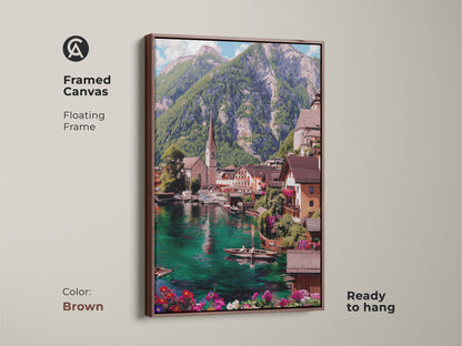 Framed canvas displaying a teal lake village with a brown floating frame. This scenic wall decor is ready to hang and features an impressionistic mountain landscape. The European town artwork brings a tranquil nature view to your living space. Notice the blue green water and charming details.