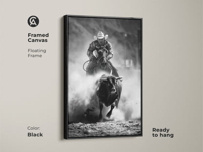 Black framed canvas with floating frame featuring black and white rodeo art. This bull riding canvas print showcases western cowboy wall art. A rustic ranch art print is ready to hang. Ideal action sports photography for man cave rodeo decor.