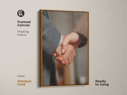 Handshake canvas art in a framed floating frame with an antique gold finish. Ready to hang. This business partnership artwork signifies corporate success. Enhances modern office decor. A professional gift showcasing collaboration. Neutral colors offer a sophisticated touch.