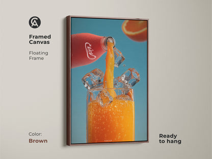 Framed canvas art featuring a refreshing orange juice pour. The brown floating frame adds warmth to this modern kitchen artwork. A vibrant red bottle pours juice into a glass with ice against a blue background. Perfect for a home bar or juice lover gift.