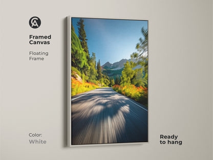 White framed canvas art displaying a mountain road. The floating frame offers a clean and modern look. This ready-to-hang artwork brings a refreshing natural scene to your decor. Ideal for contemporary spaces.