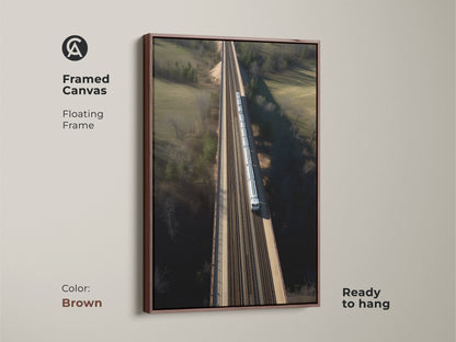 Enhance your space with this framed canvas art. It displays a modern aerial train bridge. The floating frame adds elegance. It's ready to hang. Perfect for a housewarming present. The realistic transportation artwork complements any room. This art piece has a brown frame.