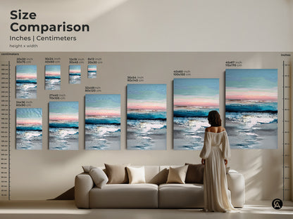 Size comparison of abstract coastal art prints in inches and centimeters. Visualize teal blue and pink artwork in various dimensions above a sofa. Choose the perfect size for your space. Create a serene ocean view art display in your home.