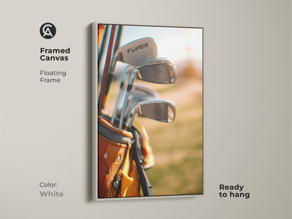 Framed canvas art of golf clubs in a tan golf bag with a floating white frame. Ready to hang. This framed golf artwork is a stylish addition to any room. Perfect for sports art collectors