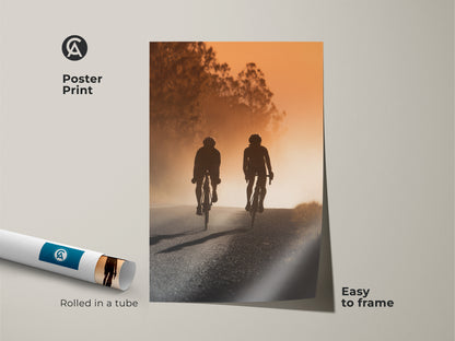 Poster print of a road cyclist silhouette. The artwork displays an amber sunset landscape. It is easy to frame. Shipped rolled in a tube. Great as cycling wall art.