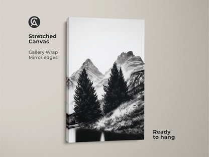 Minimalist mountain wall art printed on a stretched canvas. This black and white canvas print displays a nature landscape art of pine trees and mountains. Ready to hang this monochrome home decor brings scenic nature indoors perfect for outdoor adventure lovers.