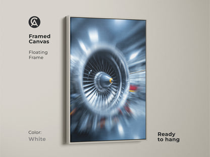 Framed abstract jet engine art with a white floating frame. This turbine blades canvas print is ready to hang. The industrial tech wall art features deep blue and steel gray tones. This artwork adds a modern and powerful statement to any room. Perfect for technology enthusiasts.