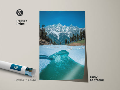 Poster print featuring a breathtaking snowy mountain and teal river scene. Rolled in a tube for easy framing this nature photography brings the outdoors inside. The blue hues and realistic details make it an excellent choice for wall art.