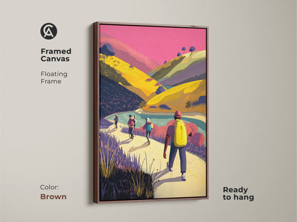 Framed canvas of hikers in a mountain landscape with a brown floating frame. This adventure travel print is ready to hang. The pink yellow and green artwork brings scenic nature decor to any space. Perfect contemporary landscape art for your living room bedroom or home office. It's an ideal gift for mountain lovers.