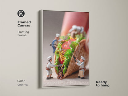This framed canvas artwork displays tiny chefs making a huge taco. The floating frame in white adds warmth to this food art. It's ready to hang and ideal for kitchen decoration. A unique and playful piece that brings an artistic touch to your home. Get yours today.