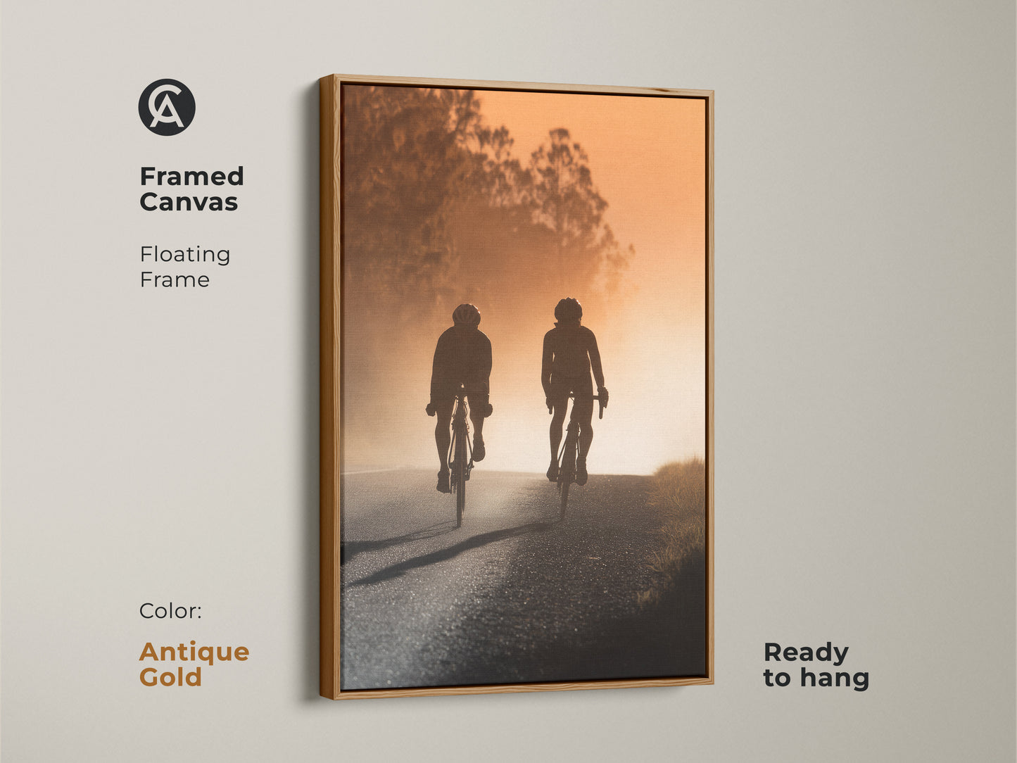 Framed canvas art with a road cyclist silhouette. The artwork has an antique gold floating frame. It shows a warm amber sunset landscape. Ready to hang this modern sport art.