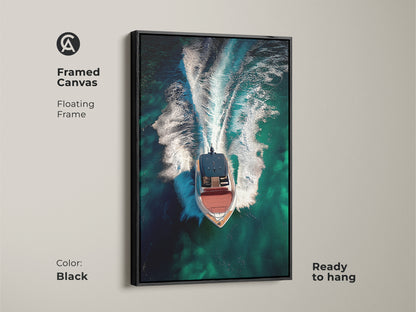 Framed canvas featuring aerial speedboat artwork with a black floating frame. The emerald green ocean wall art highlights turquoise waters. Ready to hang this contemporary nautical art is ideal executive office wall art.