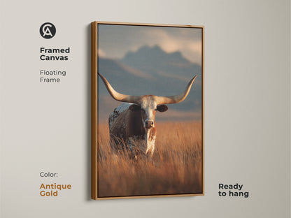 Antique gold framed canvas of longhorn cattle. This floating frame is ready to hang. The rustic western landscape uses warm earth tones. This farmhouse wall decor captures the beauty of wildlife. This animal art print is perfect for a cowboy ranch style home.