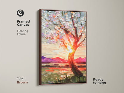 Framed canvas with a brown floating frame showcases a textured print of a blooming tree against a sunset. The impressionist landscape art brings vibrant nature decor to any space. Ready to hang this boho nature artwork makes a thoughtful housewarming gift adding warmth and color.