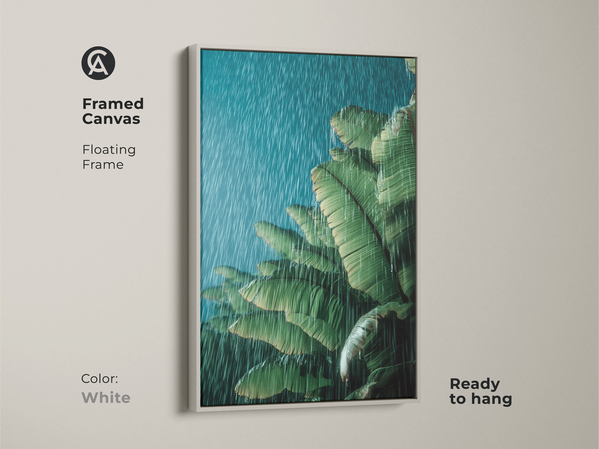 White framed canvas print featuring tropical banana leaves in rain. The green botanical wall art is ready to hang. The floating frame accentuates the serene nature of the artwork. This boho plant lover gift brings a touch of tranquility to any room. Perfect for calming bedroom decor or office plant wall.
