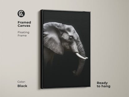 Framed monochrome elephant canvas in a black floating frame. Ready to hang black and white wildlife artwork adds a contemporary touch. Ideal animal portrait canvas for modern office wall art. This elegant animal print is a perfect gift for wildlife enthusiasts.