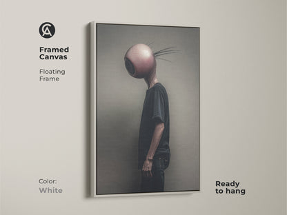 Featured is a framed canvas displaying an eyeball head alien character. The white floating frame gives this surreal art a clean modern look. Enhance your alternative bedroom decor with this dark art print. It is the perfect gift for those who appreciate unique wall art.
