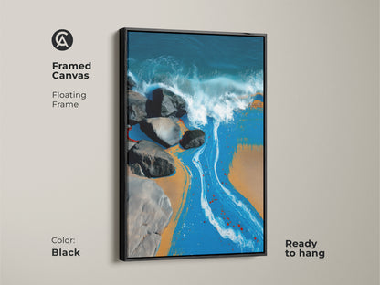 Framed canvas floating frame in black. This coastal artwork captures ocean waves crashing against rocks on a sandy beach. The abstract modern art is ready to hang in any space.