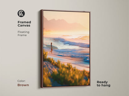 Framed canvas art in a brown frame. The artwork features a surfer walking along the beach at sunrise. Floating frame adds depth. Ready to hang. Add warmth to your decor with this brown framed canvas.