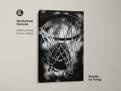 Stretched canvas basketball artwork. This gallery-wrapped canvas features mirror edges. The black and white sports art shows a basketball in a net. The canvas is ready to hang. Add a modern touch to your home decor with this piece.