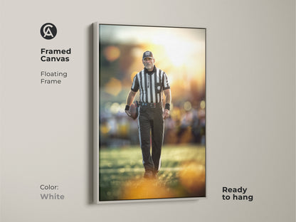 Framed canvas art of a football referee. The floating frame is white. This ready to hang artwork brightens any office. It's ideal sports action photography for a sports enthusiast's gift.