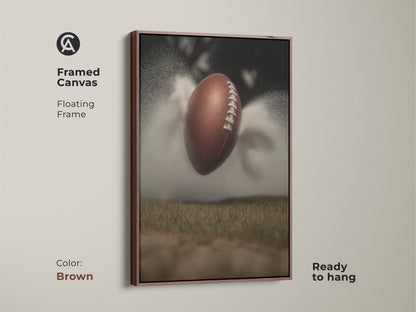 Enhance your decor with this dynamic football art print framed in brown. This sports action canvas is perfect for a modern office or man cave. It's a great gift for any sports lover. The artwork features a textured football against a misty field bringing an athletic touch to any room.