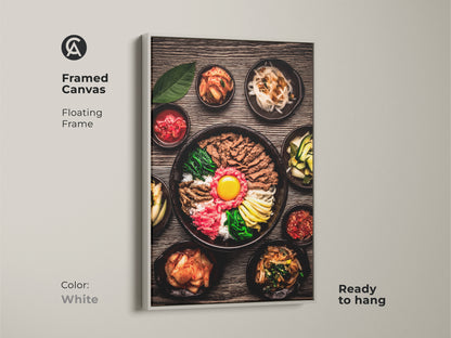 Framed Canvas featuring realistic Bibimbap artwork Korean gourmet food photography. It features a white floating frame and comes ready to hang. This vibrant food canvas will enhance your home decor.