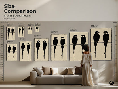 Size comparison of minimalist bird artwork in inches and centimeters. See how the black cream art print fits above a sofa for scale. The modern abstract animal art comes in various sizes. Visualize the impact of this Scandinavian-style art. Perfect for a bird couple artwork.