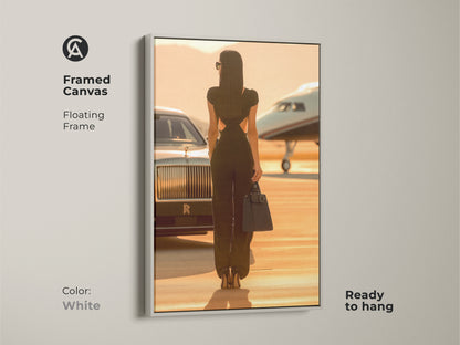 Framed canvas featuring a woman with a private jet and car. The floating frame is white. Ready to hang for a modern look. This luxury car canvas print adds sophistication to any space. Ideal for contemporary home galleries.