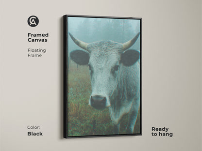 Framed canvas artwork featuring a cow in a misty field with a black floating frame. This ready-to-hang piece enhances your home decor. A sleek and modern art choice.