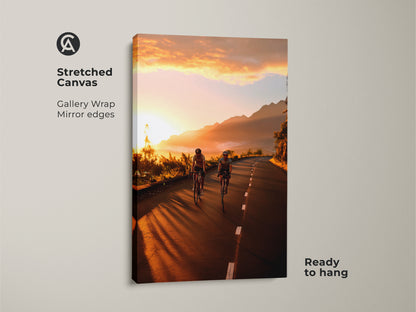 Stretched canvas art of cyclists on a mountain road at sunset. Gallery wrapped with mirror edges and ready to hang. This cycling wall art brings warm yellow and golden orange tones to your space. Ideal for contemporary and travel-themed decor. A perfect gift for cyclists.