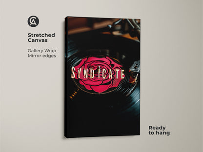 Stretched canvas print of Syndicate vinyl record art. A red rose design on a vinyl record with gold typography. Gallery wrap with mirror edges is ready to hang. Ideal music enthusiast decor.