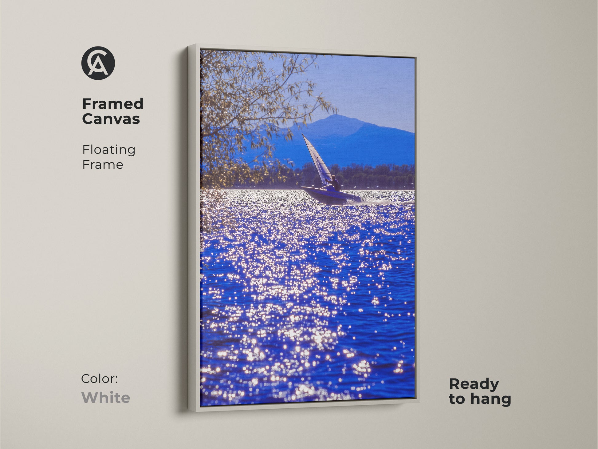 A framed canvas features sailboat art on blue water with a mountain view. The white floating frame enhances this coastal artwork. This ready-to-hang nautical scene is ideal for home decor. It's a beautiful maritime wall art.