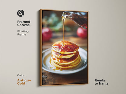 Framed canvas art of pancakes with golden syrup. The floating frame in antique gold adds elegance to the food photography. It's ready to hang and perfect for kitchen decor. The amber and yellow tones create a cozy atmosphere. Ideal for gifting.