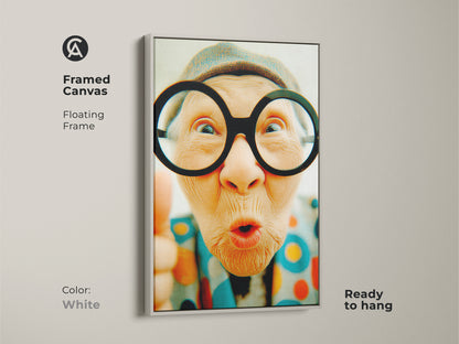 Framed canvas artwork of a senior woman with funny glasses. The artwork features a clean white floating frame. This contemporary piece is ready to hang perfect for adding a modern touch to any room.