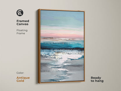 Framed canvas with antique gold floating frame showing abstract ocean artwork. This ready-to-hang teal blue and pink artwork enhances any room. The coastal landscape print adds a modern touch. A sophisticated piece for a housewarming gift for her.