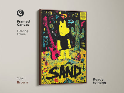 Framed canvas art print showcasing a yellow cartoon figure guitar and cactus against a black backdrop. The artwork spells out the word SAND in large black letters. This brown floating frame canvas is ready to hang.