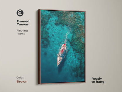 Bring coastal elegance to your walls with this framed canvas. This yacht artwork features a floating frame in brown. The aerial view captures the beauty of the yacht. Elevate your decor with this framed artwork today ready to hang.