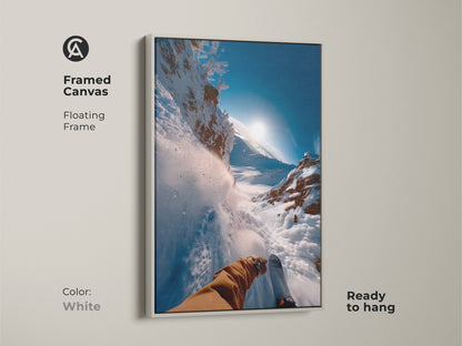 Framed canvas artwork with a white floating frame. A skier's eye view of a thrilling downhill run. The bright white frame complements the snowy landscape. This ready-to-hang art adds a fresh look to your home decor.