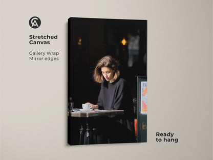 Gallery wrapped canvas of a woman reading at a cafe. A contemporary art print. Black and white tones create a modern aesthetic. Ideal coffee lover housewarming gift.