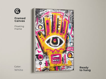 White framed canvas of abstract artwork. The clean white frame highlights the yellow and pink hand with an eye. This modern art is ready to hang. A stylish choice for any contemporary space.