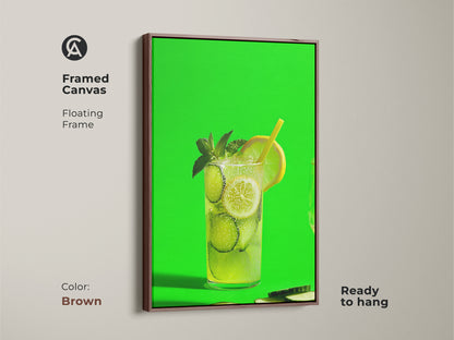 Framed canvas with a brown floating frame showcasing lime green cucumber lemonade art. This refreshing artwork is ready to hang. The contemporary style makes it ideal for a modern kitchen. It is perfect for a home bar.