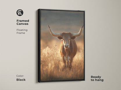Framed canvas art of a longhorn bull in a savanna. This rustic western wildlife art features earthy tones and a black floating frame. The photorealistic bull canvas is ready to hang. It will add character to any room. This is perfect as rustic wall art.